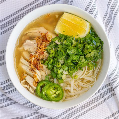 Chicken pho recipe - Cover with a lid and bring to a very gentle simmer. Add chicken and continue to simmer very gently for about 15 minutes. Cook the noodles according to the package instructions. Rinse well under cold water to prevent sticking and divide between 4 bowls. Remove the cooked chicken from the soup and slice. Arrange over noodles with cooked shallots ...